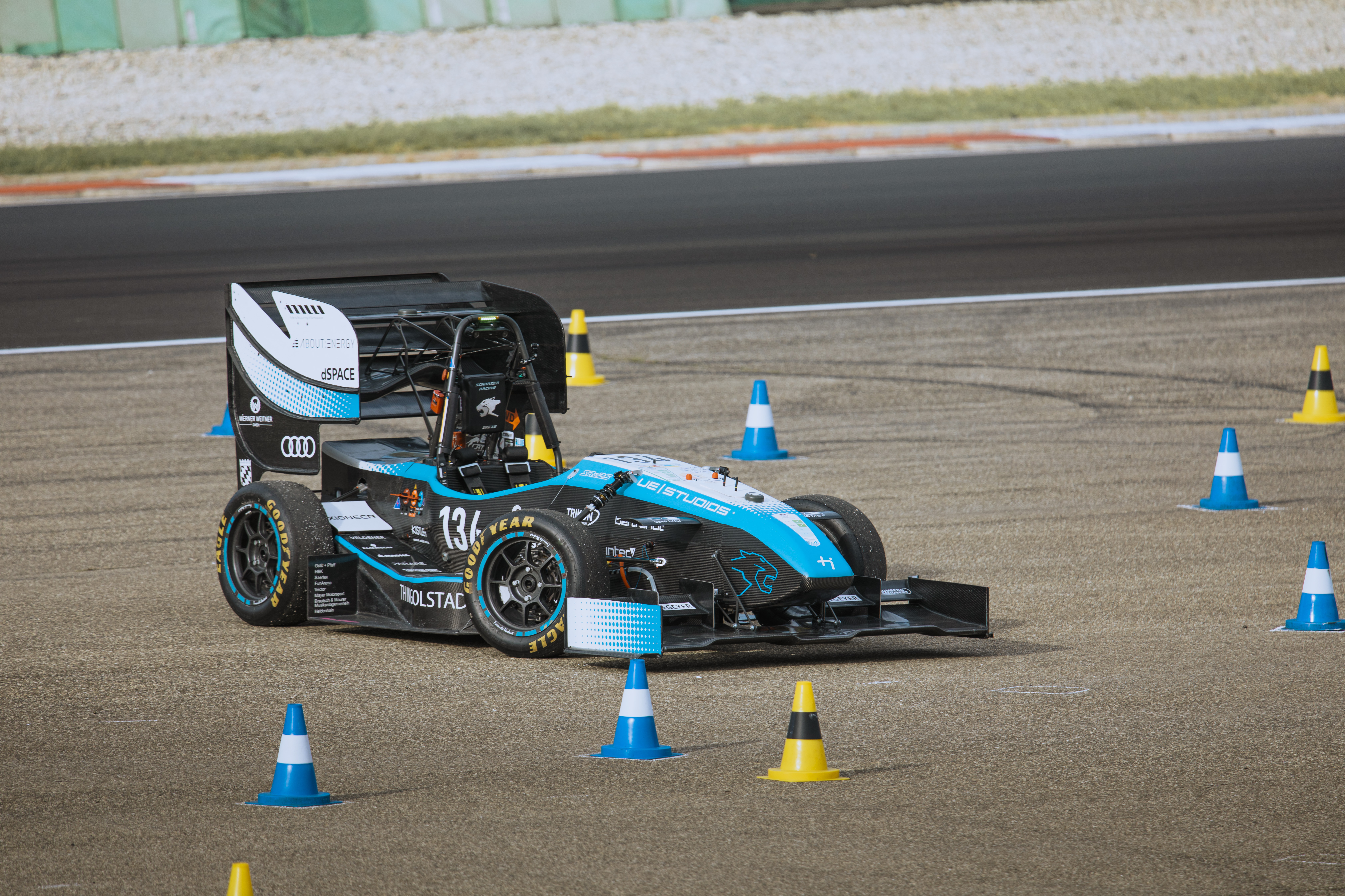 Autonomous Formula Student racecar driving through a cone course at FS Italy 2025
